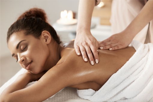 Woman looking relaxed enjoying a back massage in a salon