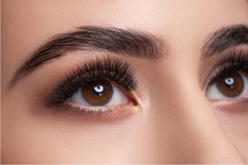 Close up of a woman with beautiful eyebrows and full lashes